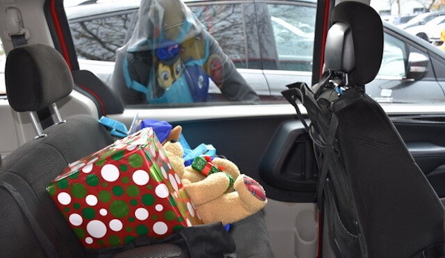 A suspect spots Christmas presents in the back of parked car. Stock Photo