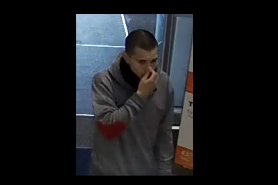Suspect in the Jan.16 theft at Walls Avenue. He is described as approximately a 25-year-old male, short dark hair wearing a grey hoodie with elbow patches.  (via RCMP)