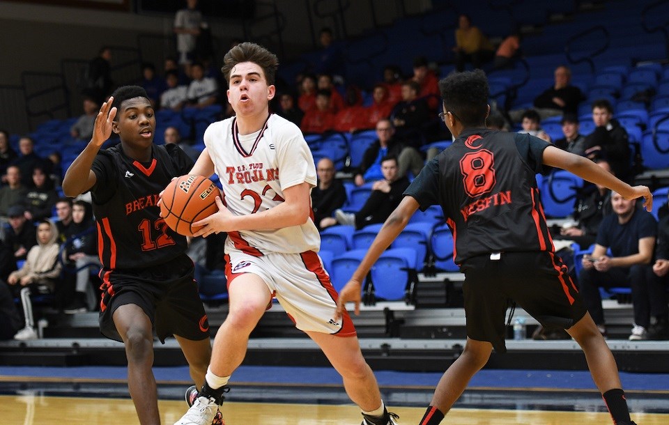 Prince George's Cam Sale (#23) breaks through a pair of defenders for the D.P. Todd Trojans at the 2019 B.C. AA Boys' Provincial Championships. (via Handout photo)