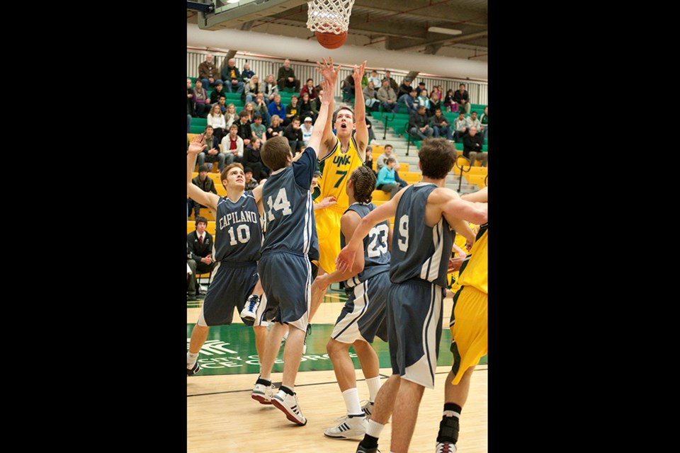 Prince George's Dennis Stark takes a jump shot in a game with the UNBC Timberwolves' men's basketball team.