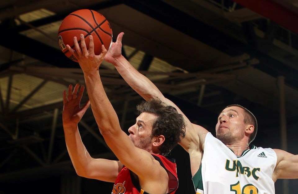 Vova Pluzhnikov (#13) reaches for the block during a UNBC road game in Calgary (via David Moll)