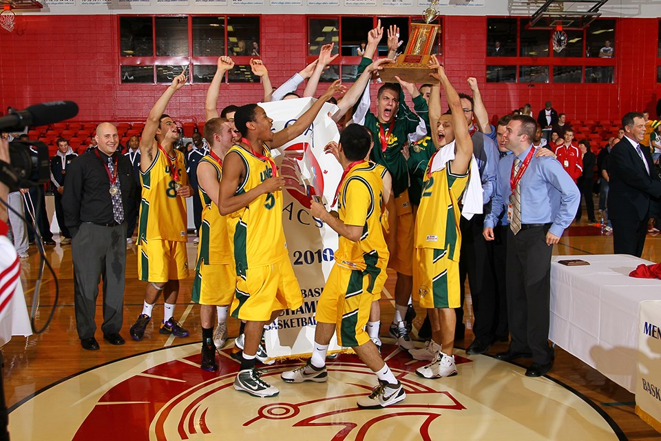 The 2010 UNBC Timberwolves men's basketball team lifts the CCAA National Championship trophy.