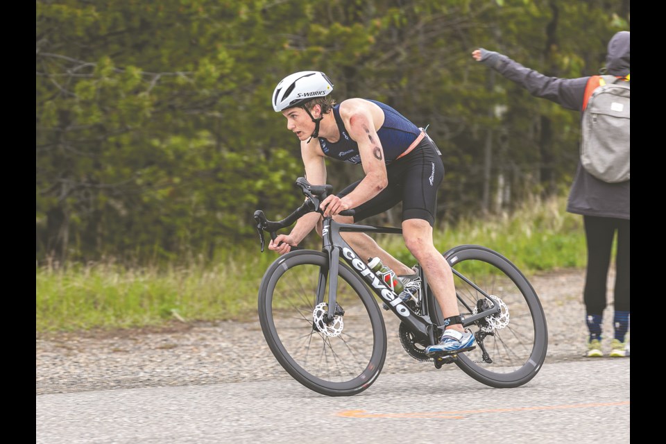 Josiah Wilkinson heads out on one of his eight laps on his bike as he competes in the Men's Sprint 16-19 division of the PG Northern Triathlon Sunday, May 26, 2024 at the Prince George Aquatic Centre. The race route was changed when there was a problem with traffic control forcing modification of the 20KM cycling course.

