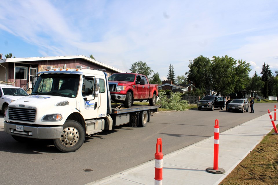 A red pickup truck is loaded onto a flat-bed after some kind of incident on Stuart Drive near the intersection with Fifth Avenue just after 4 p.m. on Thursday, July 17, 2025.