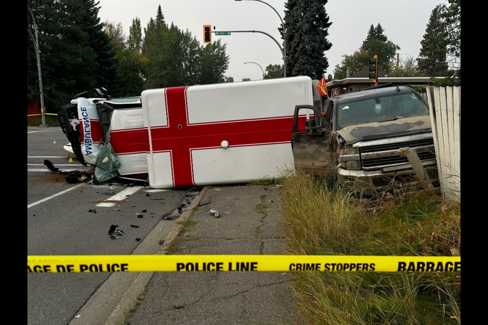 Police work at the scene of a collision involving an ambulance and a pickup truck towing a boat at the intersection of 15th Avenue and Carney Street on Friday, Sept. 5, 2025 in Prince George, BC.