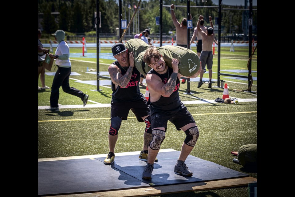 Chance Thompson, 28, and Lucas Samways, 33, of Williams Lake do sandbag carries during day two of the Battle of the North at Masich Place Stadium Sunday, June 8, 2025.