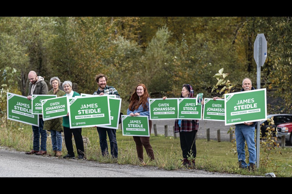 BC Greens supporters, including MLA candidates Gwen Johansson and James Steidle, wave campaign signs on River Road at the launch of the BC Greens Campaign Thursday at Cottonwood Island Park.
