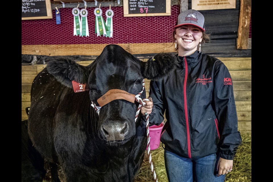 Amy Larson, 19, poses with her Simmental/Angus steer Joe on Saturday, August 16, 2025 after winning Reserve Champion Market Steer, Reserve Champion 4H Angus and Grande Overall Showman titles at the 2025 BCNE.