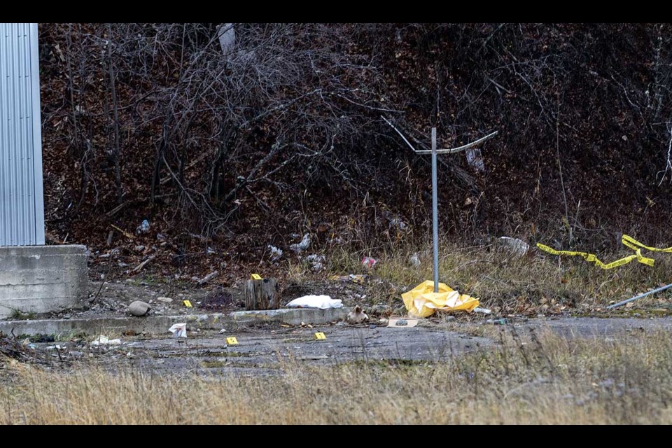 Police tape and evidence markers define the area where a body was found following a shooting Wednesday 15th and 17th Avenues on Victoria Street Thursday.