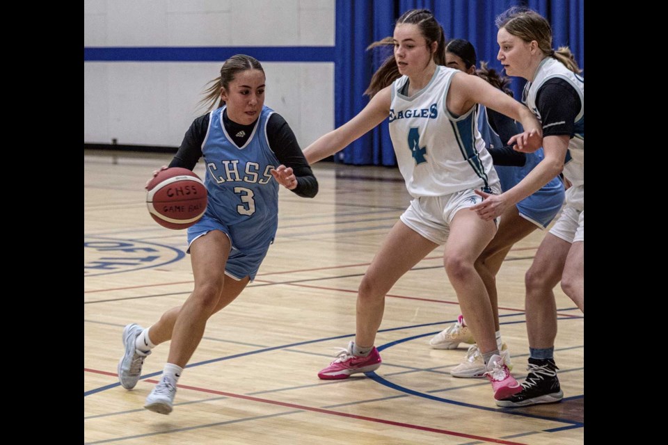 CHSS Cougar #3 Lorenn Caceres drives around Cedars Eagles #4 Mila Johnson during Friday night's game at the CHSS Girls Basketball Tournament.