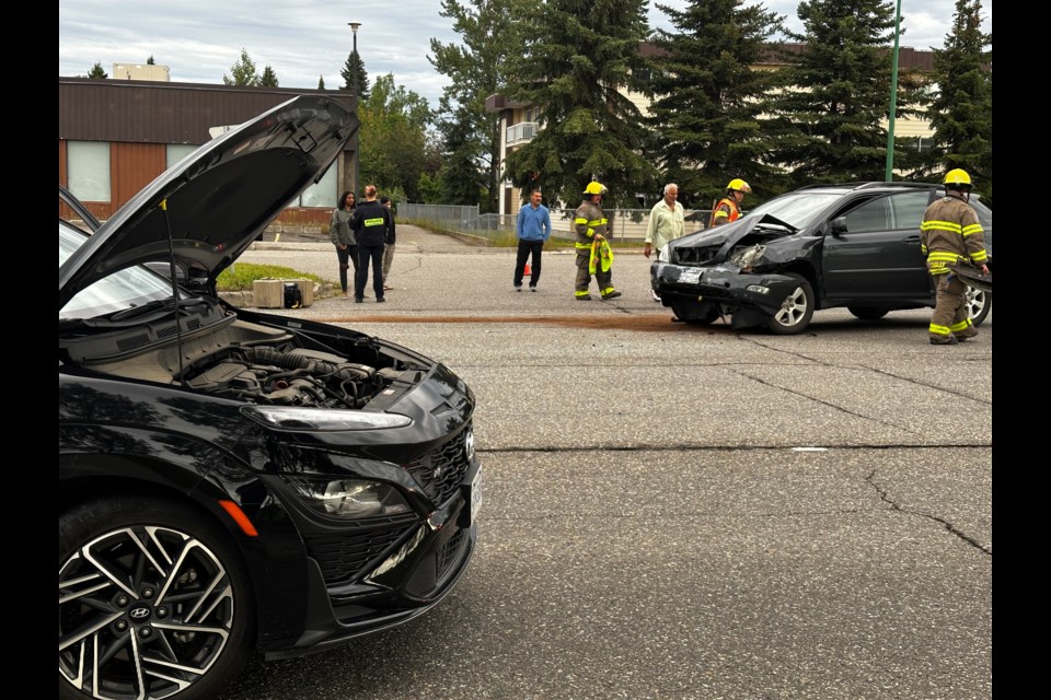 Prince George Fire Rescue firefighters and Prince George RCMP work at the scene of a collision on 15th Avenue just west of Ospika Boulevard on Sunday, Aug. 10, 2025 in Prince George, BC.