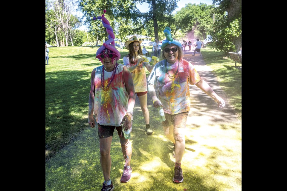 Joan Harris (left) and Carla Brooks get into the spirit of the Prince George Hospice Palliative Care Society Colour Walk topped off with headgear created by Bell E. Buttons at Lheidli T'enneh Memorial Park Saturday, June 7, 2025.