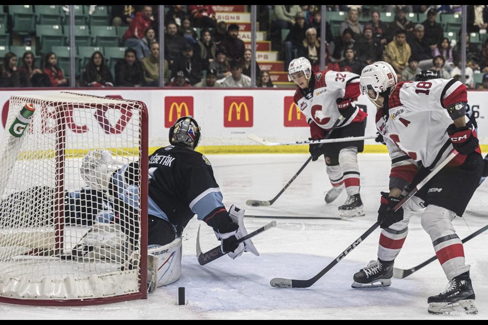 Cougars forward Terik Parascak takes a shot as Winterhawks goalie Ondrej Stebetak knocks the goal off its mounts in overtime Friday, March 28, 2025 at CN Centre.