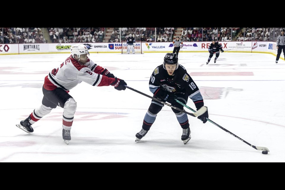 Cougar Viliam Kmec stretches to block Winterhawk Kyle Chyzowski's stick as the Portland player tries to fire the puck toward the goal in game six of their first round playoff series at CN Centre Sunday, April 6, 2025.