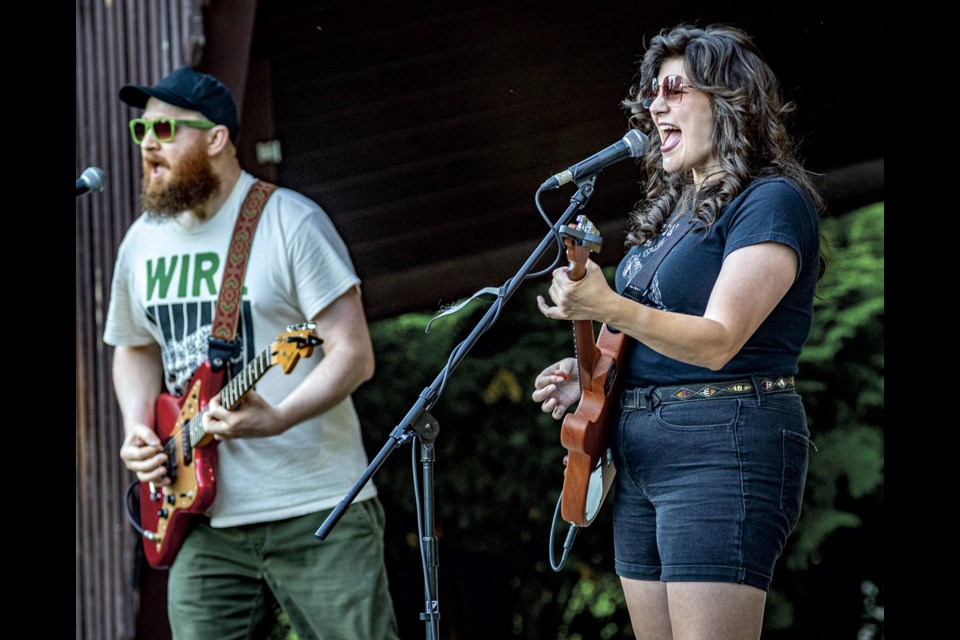 Nathan Kelly (left) and Britt Meierhofer of Britt A.M. play the final set of music for the CUPE Concert in the Park and Active Living Market held at Lheidli T'enneh Memorial Park Friday, August 22, 2025.