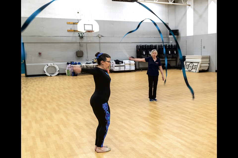 Special Olympics athlete Darcie Muzychka works with the ribbon as coach Dee Neukomm takes her through exercises during practice in the gym at AimHi Thursday, June 12, 2025. They are preparing for the BC Summer Games taking place from July 10 to 12 in Prince George.