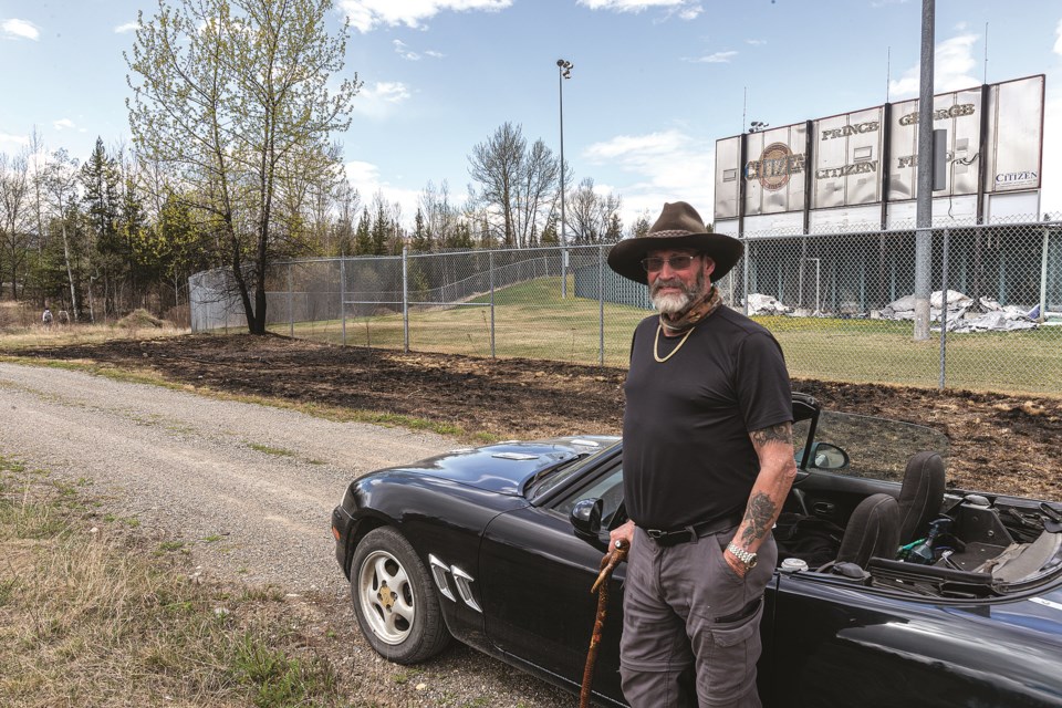 Larry Johnson stands by his car at the edge of a grassfire behind Prince George Citizen Field in Carrie Jane Gray Park Friday afternoon after noticing the burned out area that almost ignited a tree. Johnson believes the fire was caused by the careless discarding of a cigarette butt and is worried that similiar action could have dire consequences this summer.
Citizen photo by Chuck Nisbett