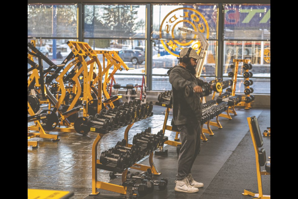 Juan Mendez gets in a workout with free weights during a quiet afternoon at Gold's Gym Wednesday.