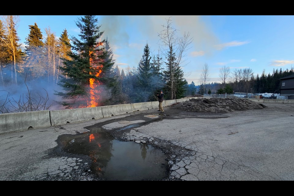 Prince George Fire Rescue crews battle a tree fire at the corner of Northwood Pulp Road and Aberdeen Road on Saturday, April 26, 2025 in Prince George, BC.