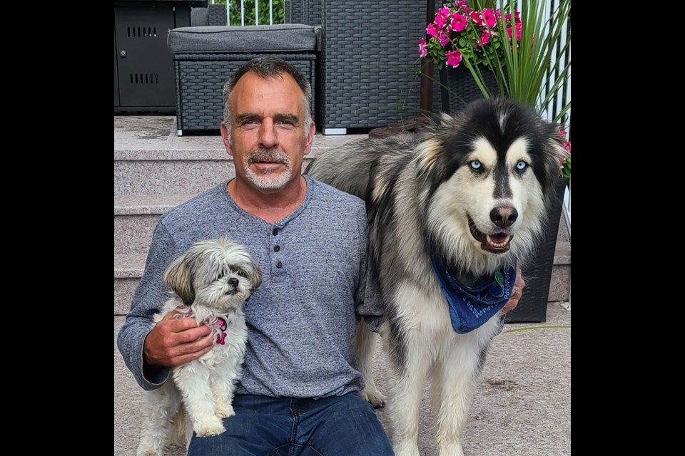 Prince George city councillor Brian Skakun with his dogs Kato, right, and Tika. On Saturday Kato fell through the ice on the Fraser River and Skakun had to act quickly to free him from his icy trap.