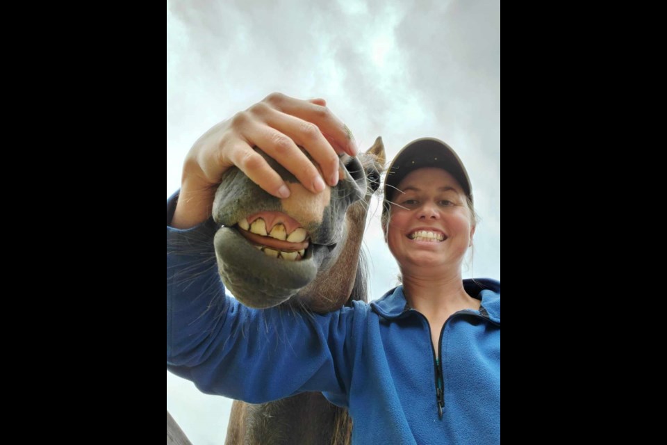 Miracle Milton is seen here being his goofy self with owner Nicole Klassen who gave her horse a second chance at life. Prince George author Dustie Hall has written a children's book to tell his story.