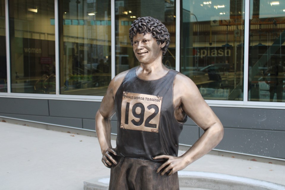 A bronze statue of Terry Fox stands in front of the Canfor Leisure Pool.