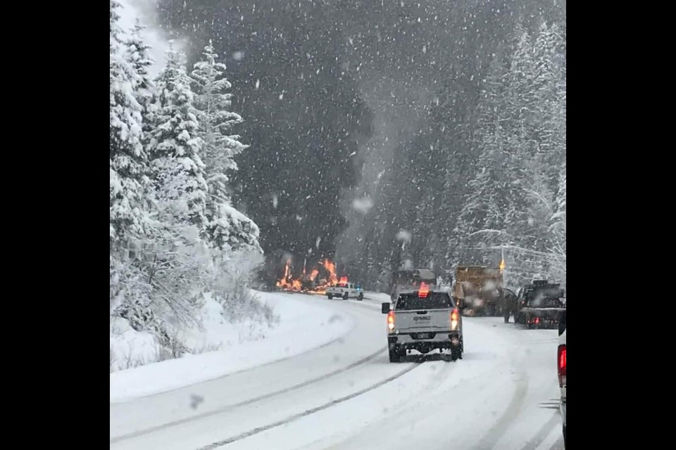 A passenger bus and a semi-trailer truck burn after they collided head-on Saturday afternoon on Highway 16, 39 kilometres west of McBride. The driver of the truck died at the scene and 13 people on the bus were njured.