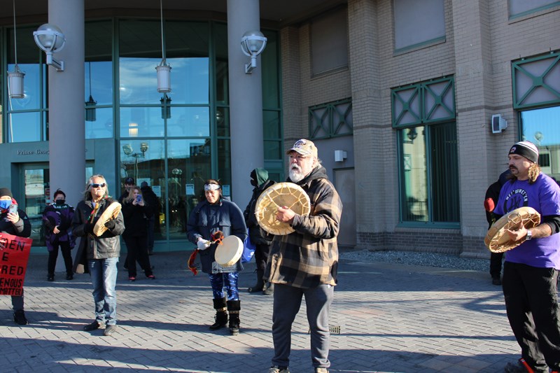 A crowd of about 50 people gathered on the steps of the Prince George courthouse Monday with drums and signs in support of those who were detained.