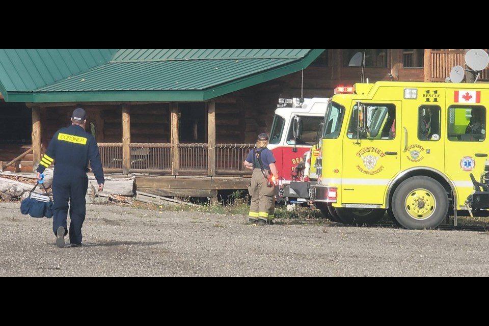 The coroner arrives near the scene of a helicopter crash east of Prince George