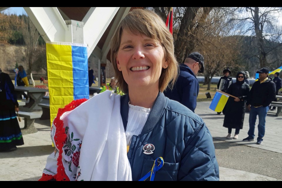 P.G. Solidarity Walk For Ukraine organizer Sherry Thereukauf holds the embroidered tablecloth her grandmother made after she came to Canada after years of confinement in a Nazi concentration camp in Germany.
