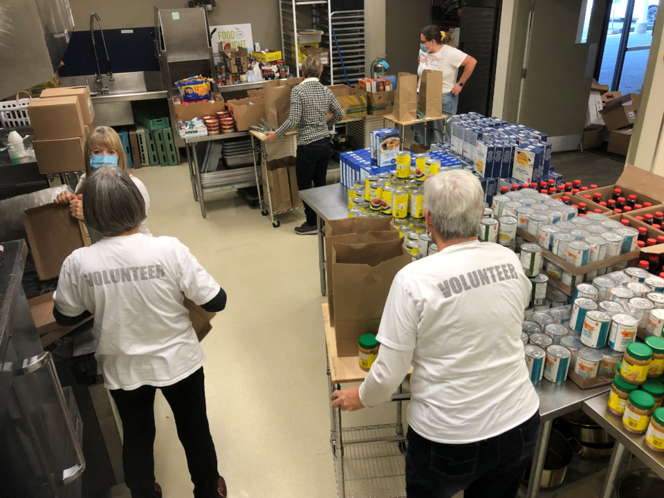 Volunteers pack essential food items for Merritt evacuees