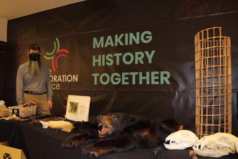 The Exploration Place board chairperson Peter James stands with some of the exhibits on display at the museum's pop-up location in Pine Centre Mall on Friday.