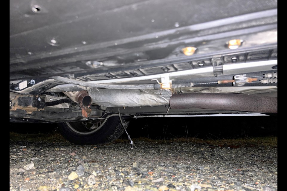 This RCMP photo shows the underside of a vehicle after a thief stole the catalytic converter.