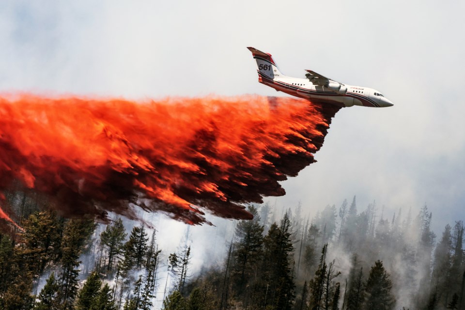 An Avro RJ85 land-based tanker owned by Conair Aerial Firefighting of Abbotsford drops its load of retardant. Conair has 29 aircraft committed to fighting B.C. wildfires.