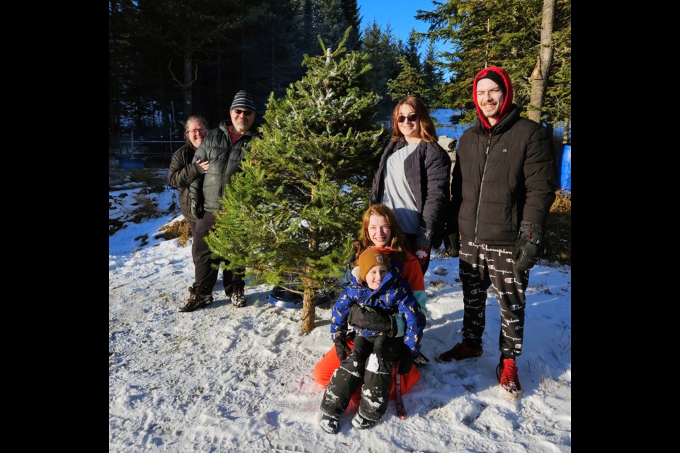 At the end of a successful hunt at Happy Pappy's Christmas Tree Farm northeast of Prince George Airport, farm owner Don Ferrey always snaps of photo of the people who come to pick out and cut down their own trees.