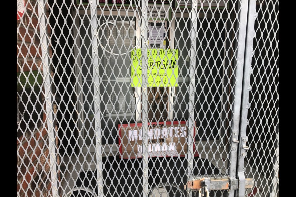 Signs posted on the door of Lamba Cabaret on Wednesday say "Constitutional rights supercede government authority" and "Medical mandates violate human rights."