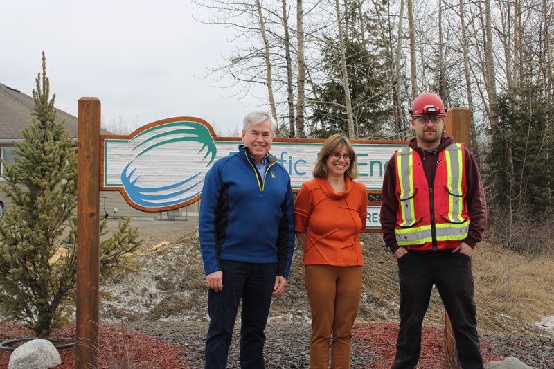CEO John Stirling, VP finance Karen Staahl, and production supervisor Aron Moscrip stand infront of the PacBio sign. 