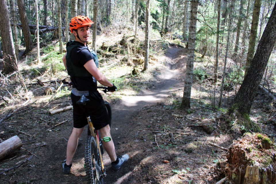 Rider Russell Phillips stops to check out the scenery on the Shady Lane trail, one of the lower trails affected by logging to reduce fire risk at Pidherny Recreation Site.
