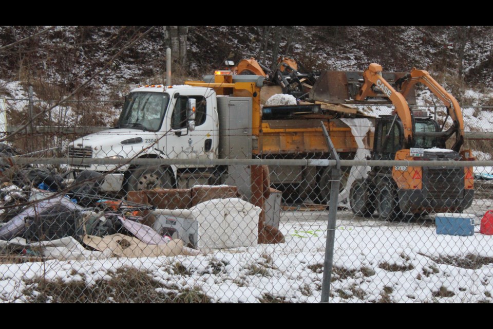 A loader dumps debris from Moccasin Flats into a City of Prince George truck on Nov. 17, 2021.