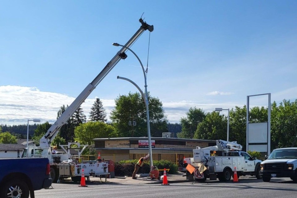 The traffic light standard that was taken out by a semi truck's moose bumper on Friday, May 16 is  replaced Wednesday, June 4, 2025. A worker used some leverage to get the light standard just right to secure it properly.