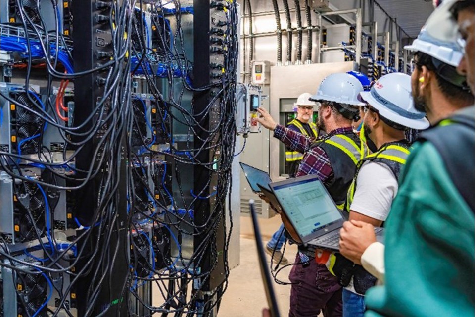 Electricians energize the Bitcoin mining computers at Iris Energy's Bitcoin mining operation in Prince George in September.