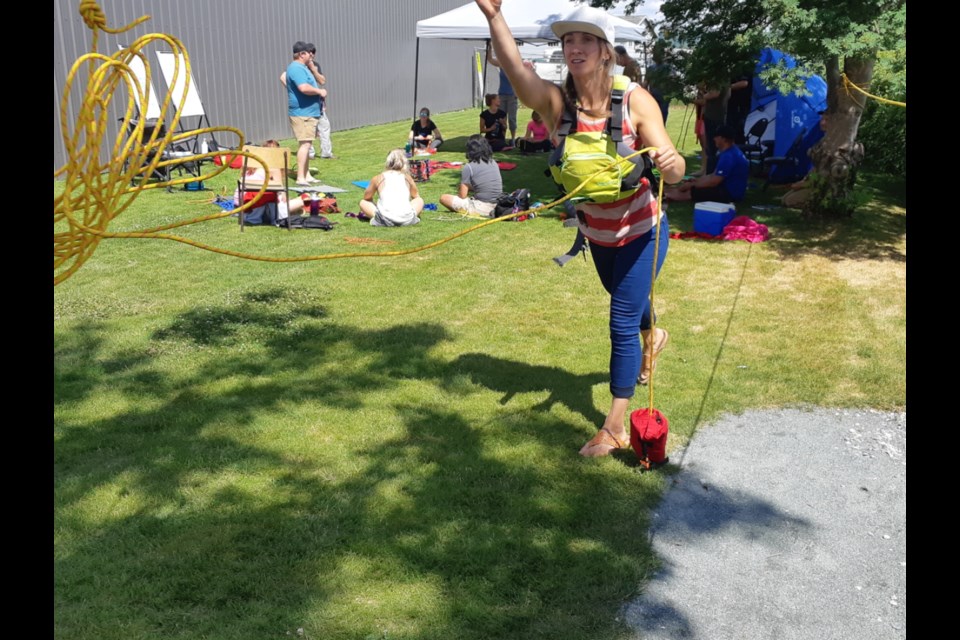 Kimberley Kenyon practices her rope tossing technique as part of the OVERhang Climbing Gym, swiftwater safety and rescue course outside the gym headquarters at the Prince George Golf and Curling Club.
