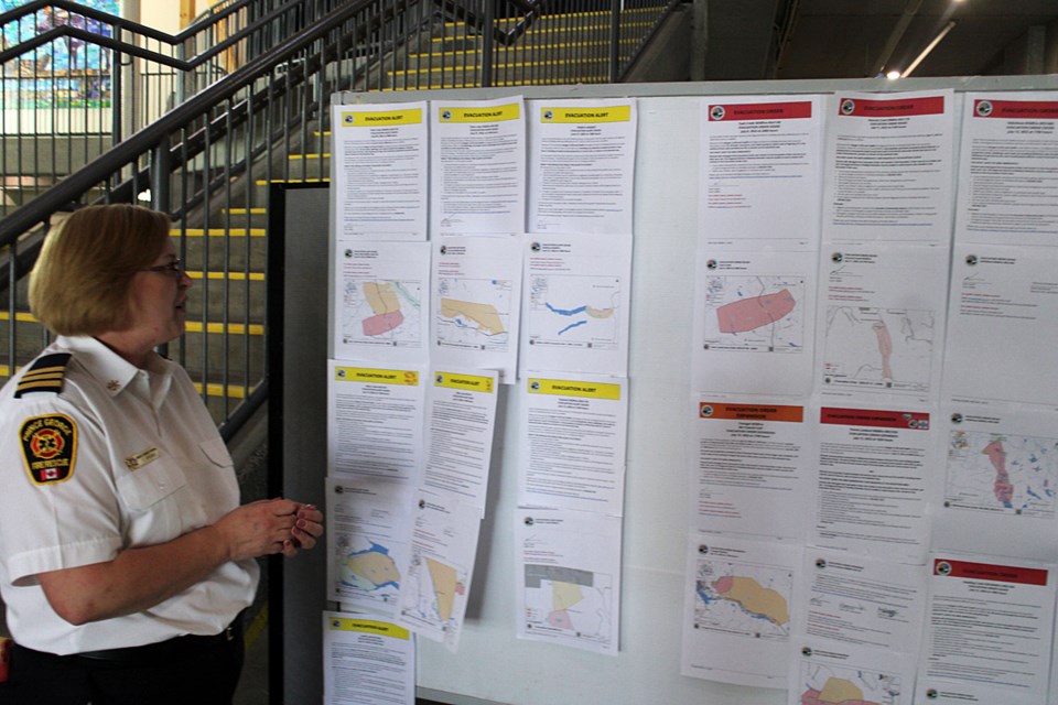 Tanya Spooner, City of Prince George manager of emergency programs, checks out an information board for wildfire evacuees at the city emergency reception centre on Wednesday.