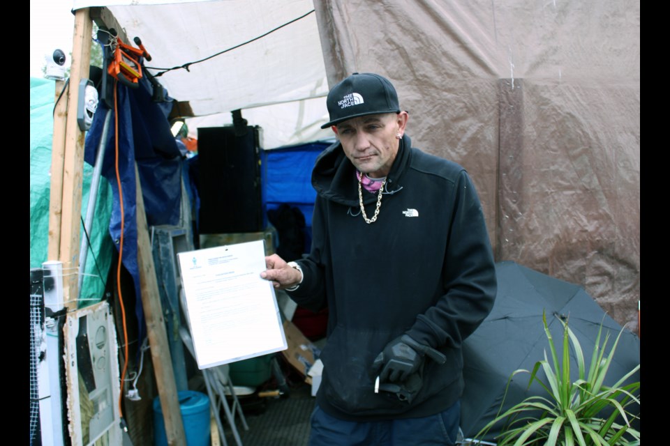 James Munro is seen here holding the city's eviction notice from Millennium Park. He was one of the first on the scene of the Aug. 22 explosion that rocked downtown Prince George and he helped victims of the blast escape.