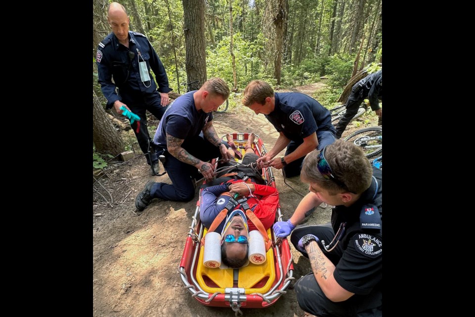 Taylor LaMarre is loaded onto the 'big bike' clamshell stretcher by first responders who carried him out of the woods after a bike accident that broke his back last week at Pidherny Recreation Site.