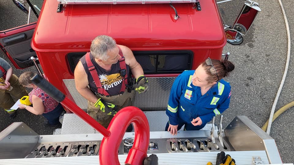 Members of the Buckhorn Volunteer Fire Department practice operating the fire truck  equipment.