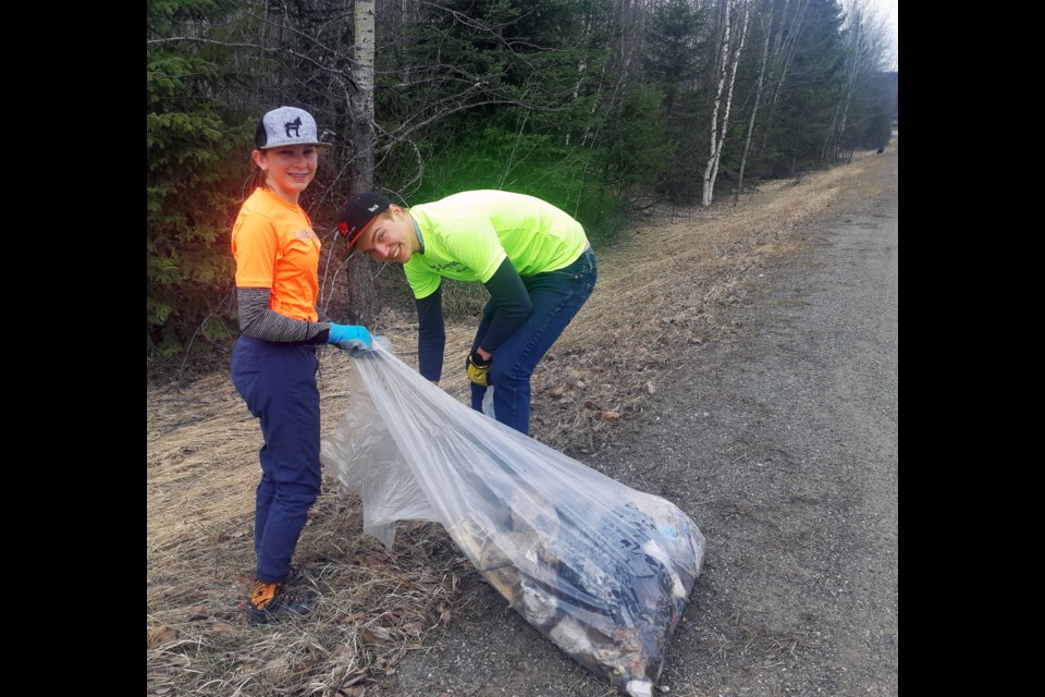 Isla Cadell, left, and Liam Sinclair do their part to beautify the city along Otway Road during the REAPS spring cleanup on Sunday. 