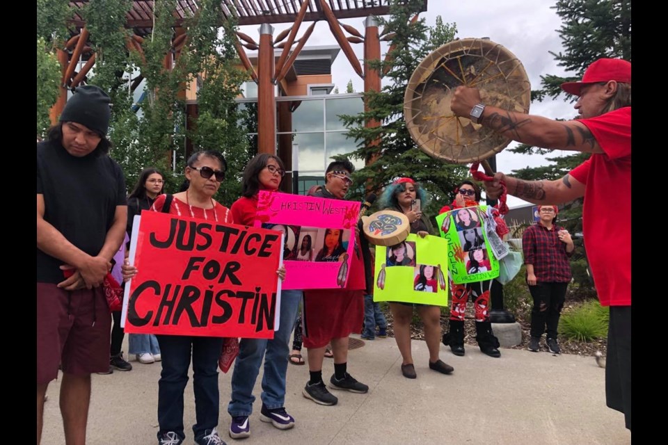 Many participants brought signs in honour of Christin West. 
