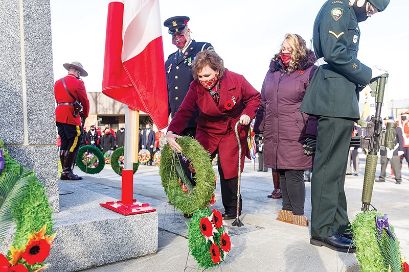 Citizen Photo by James Doyle. Silver Cross Mother Michelle Tott, joined by her husband Craig, and daughter Delaney, places a memorial wreath on the cenotaph in Veterans Plaza on Thursday morning at the Prince George Remembers Remembrance Day ceremony.