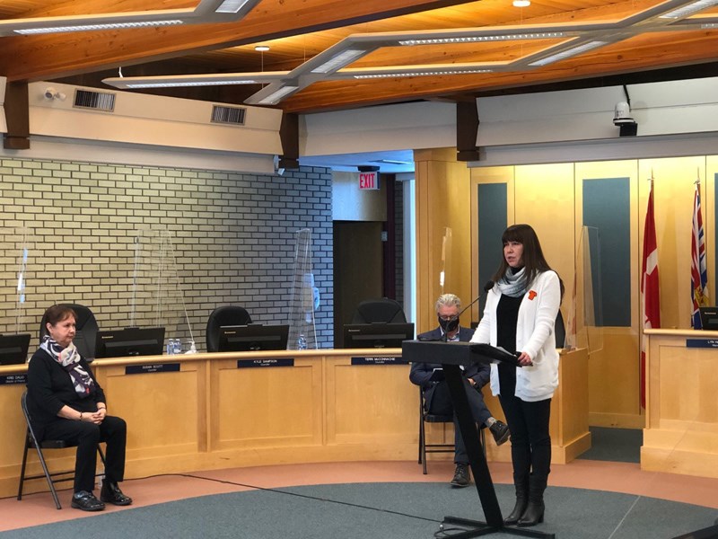 Chief Dolleen Logan gives a speech in city council chambers prior to the flag raising. 